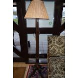 AN EARLY 20TH CENTURY MAHOGANY STANDARD LAMP, column style upright on four outward splayed legs,