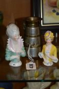 A NOVELTY MONEY BANK, shaped as milk churn (a.f), together with two pin cushion dolls (3)
