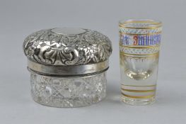 A GERMAN SILVER EMBOSSED AND GLASS JAR, and a Russian shot glass (2)