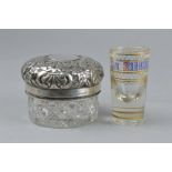 A GERMAN SILVER EMBOSSED AND GLASS JAR, and a Russian shot glass (2)