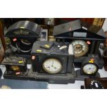 FOUR VARIOUS LATE 19TH/EARLY 20TH CENTURY BLACK SLATE AND PAINTED METAL MANTEL CLOCKS, and an