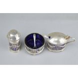 A GEORGE V MATCHED SILVER CRUET SET, in the garland style with openwork rectangular frame and swag