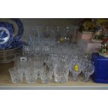 A QUANTITY OF DRINKING GLASSES, including champagne flutes, wine glasses and liqueur glasses