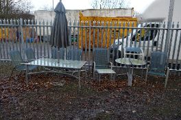 A METAL AND GLASS RECTANGULAR GARDEN TABLE, with four chairs, two loungers, parasol, two d end