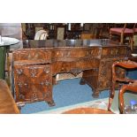 AN EARLY 20TH CENTURY CHIPPENDALE STYLE MAHOGANY SIDEBOARD, serpentine centre with central drawer,