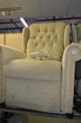 AN UPHOLSTERED ELECTRIC RECLINING ARMCHAIR