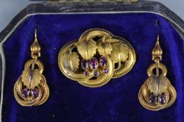 A VICTORIAN SUITE OF JEWELLERY, circa 1860, a pair of garnet ear pendants, textured and applied