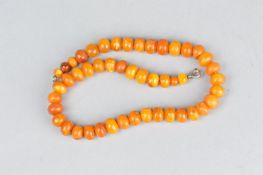 A STRING OF GRADUATED COPAL AMBER TYPE BEADS, approximate length 37cm, approximate gross weight 23.5