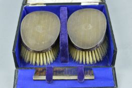 A CASED SET OF SILVER BACKED CLOTHES BRUSHES AND COMB
