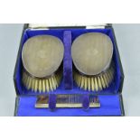 A CASED SET OF SILVER BACKED CLOTHES BRUSHES AND COMB