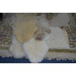 FOUR VARIOUS SKYESKYNS SHEEPSKIN RUGS, and another rug (5)