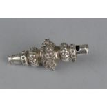 A LATE VICTORIAN SILVER RATTLE, with floral repousse decoration, whistle with suspension loop,