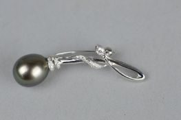 A BLACK PEARL AND DIAMOND 18CT WHITE GOLD BROOCH, the large tear drop shaped pearl with diamonds