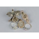 AN EARLY 20TH CENTURY SILVER BROOCH, a silver locket, marcasite ring and orchid brooch and a