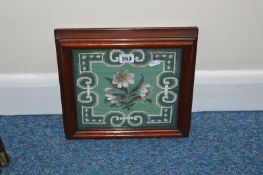 A VICTORIAN WOOL AND BEADWORK PANEL OF WHITE FLOWERS ON A GREEN GROUND, decorative border, glazed