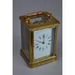 A BRASS CARRIAGE CLOCK, approximate height 10.5cm, (working) (key)