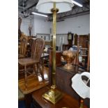 A BRASS STANDARD LAMP, with shade, brass table lamp, circular two tier trolley with a stainless