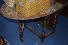 AN OAK BARLEY TWIST GATE-LEG TABLE