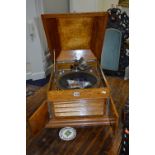A LIGHT OAK BELTONE WIND UP GRAMOPHONE, with a single record and pins (winding handle)