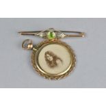 AN EDWARDIAN PERIDOT AND SEED PEARL YELLOW METAL BAR BROOCH, the central peridot within openwork