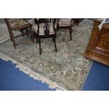 A BELCUHI SILK RUG, green ground, multi strap border and flower decoration, approximate size 295cm x