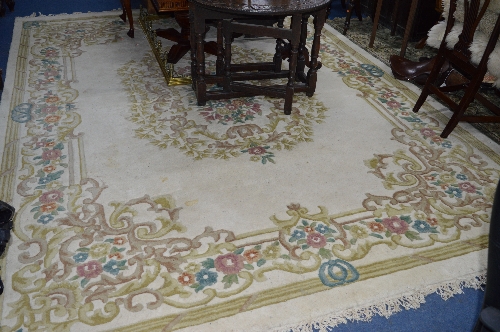 A KAYAM CHINESE WOOL RUG, cream ground and flower decoration, approximate size 370cm x 274cm and