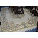 A KAYAM CHINESE WOOL RUG, cream ground and flower decoration, approximate size 370cm x 274cm and