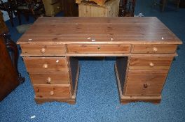 A PINE PEDESTAL DESK, with eight assorted drawers, approximate size width 137cm x height 77cm x
