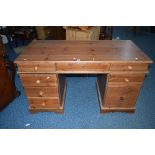 A PINE PEDESTAL DESK, with eight assorted drawers, approximate size width 137cm x height 77cm x