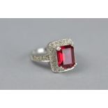 A SYNTHETIC RUBY AND WHITE STONE RECTANGULAR 9CT WHITE GOLD CLUSTER RING, ring size N, approximate