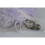 A GEORGE V SILVER HANDLED LILAC OSTRICH FEATHER FAN, the handle embossed as a young woman with