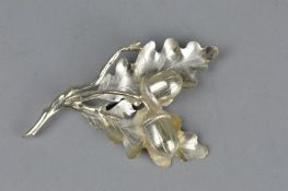 A SILVER ACORN BROOCH IN THE FORM OF TWO LEAVES AND TWO ACORNS, approximate length 9cm,