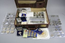 A LEATHER STYLE BRIEFCASE CONTAINING COINS AND COMMEMORATIVES