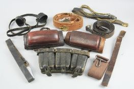 A PLASTIC BOX CONTAINING VARIOUS ITEMS OF LEATHER WEBBING, AMMUMITION POUCHES, BELTS, etc, also a