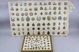 TWO FRAMES OF MILITARY BADGES AND BUTTONS, the larger has mounted 80 badges from British and