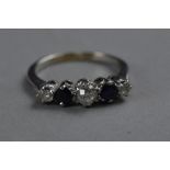 AN EARLY 20TH CENTURY FIVE STONE SAPPHIRE AND DIAMOND HALF HOOP RING, estimated on European cut