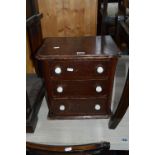 A SMALL STAINED PINE CHEST, of three drawers, approximate size width 37cm x height 38cm x depth 27cm