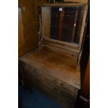 A LIGHT OAK DRESSING CHEST OF THREE DRAWERS, with a single mirror