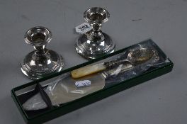 A PAIR OF DWARF SILVER CANDLESTICKS, jam spoon and cake slice