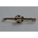 A LATE 19TH CENTURY TO EARLY 20TH CENTURY SAPPHIRE AND DIAMOND HORSESHOE BROOCH, estimated old cut