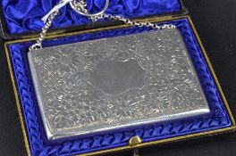A LATE VICTORIAN SILVER RECTANGULAR CARD CASE, on short chain, floral engraved decoration with