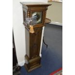 AN OAK CASED GRANDDAUGHTER CLOCK, with brass dial and Roman numerals, (winding key, pendulum and