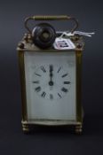A FRENCH BRASS CARRIAGE CLOCK, height 10cm (key)