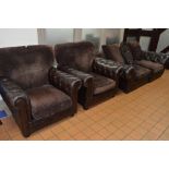 A BROWN LEATHER UPHOLSTERED BUTTONED THREE PIECE SUITE, comprising of a two seater settee and a pair