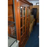 A MODERN DISPLAY CABINET, with two glazed panel doors over two drawers, approximate height 183cm