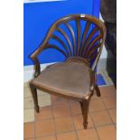 A VICTORIAN ROSEWOOD ARMCHAIR, with an arched top rail above a sunburst style back on tapering