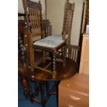 AN OVAL OAK GATELEG TABLE, with frieze drawer and four barley twist dining chairs (5)