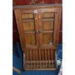 A PINE HANGING TWO DOOR CABINET, with spindled plate holder
