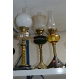 THREE VARIOUS BRASS OIL LAMPS, two with shades and funnels, other with just funnel (3)