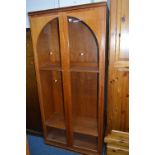 A TEAK BOOKCASE, with double domed glazed doors